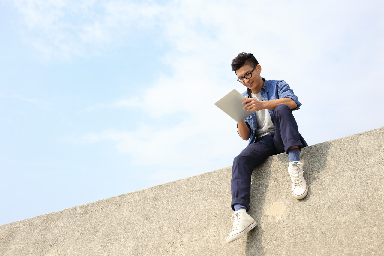 Young Boy Sitting on Wall