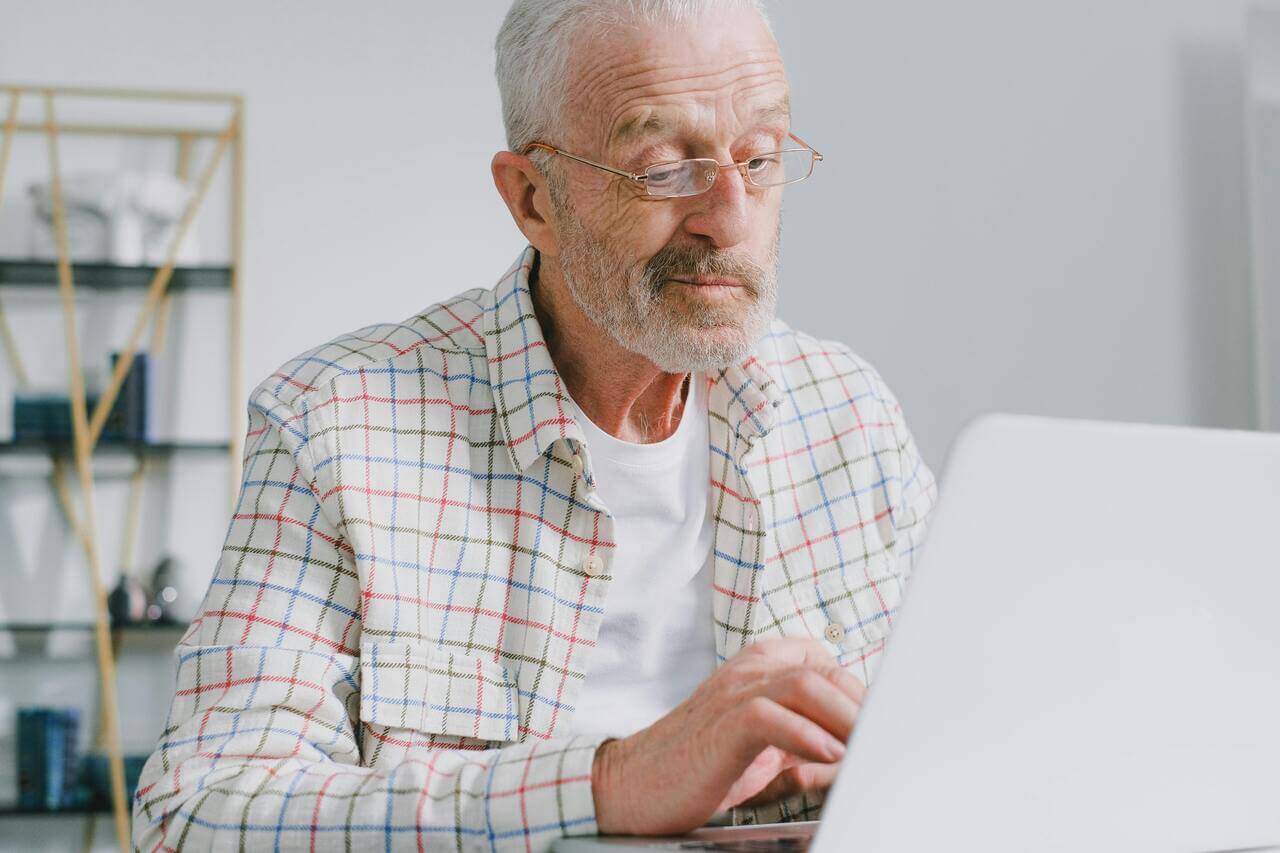 Senior Male Looking at Laptop